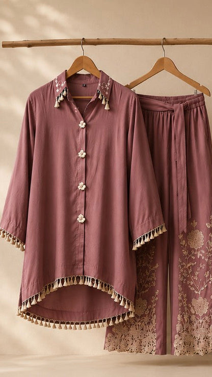 Mauve pajama set with floral embroidery on a beige background